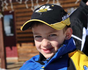 A boy enjoying snowmobiling