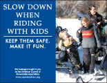 Horizontal Poster of Snowmobilers and text ‘Slow Down When Riding With Kids. Keep Them Safe. Make it Fun.'